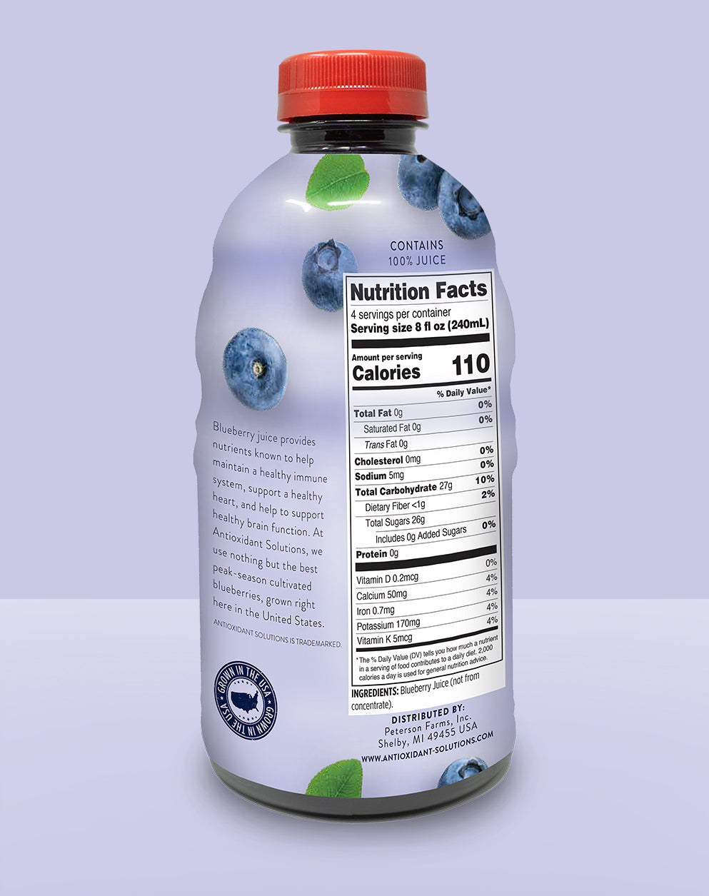 The back of a bottle of blueberry juice with a purple background.