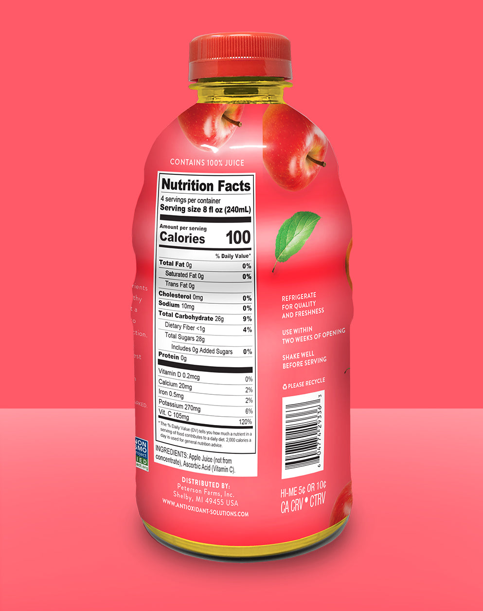 
                  
                    The back of a red bottle of apple juice with a red background.
                  
                